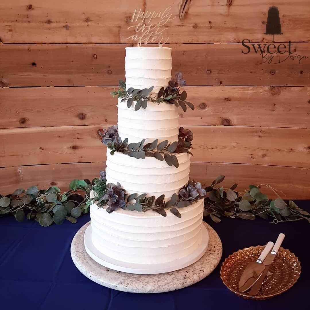 Textured wedding cake with greenery by Sweet By Design