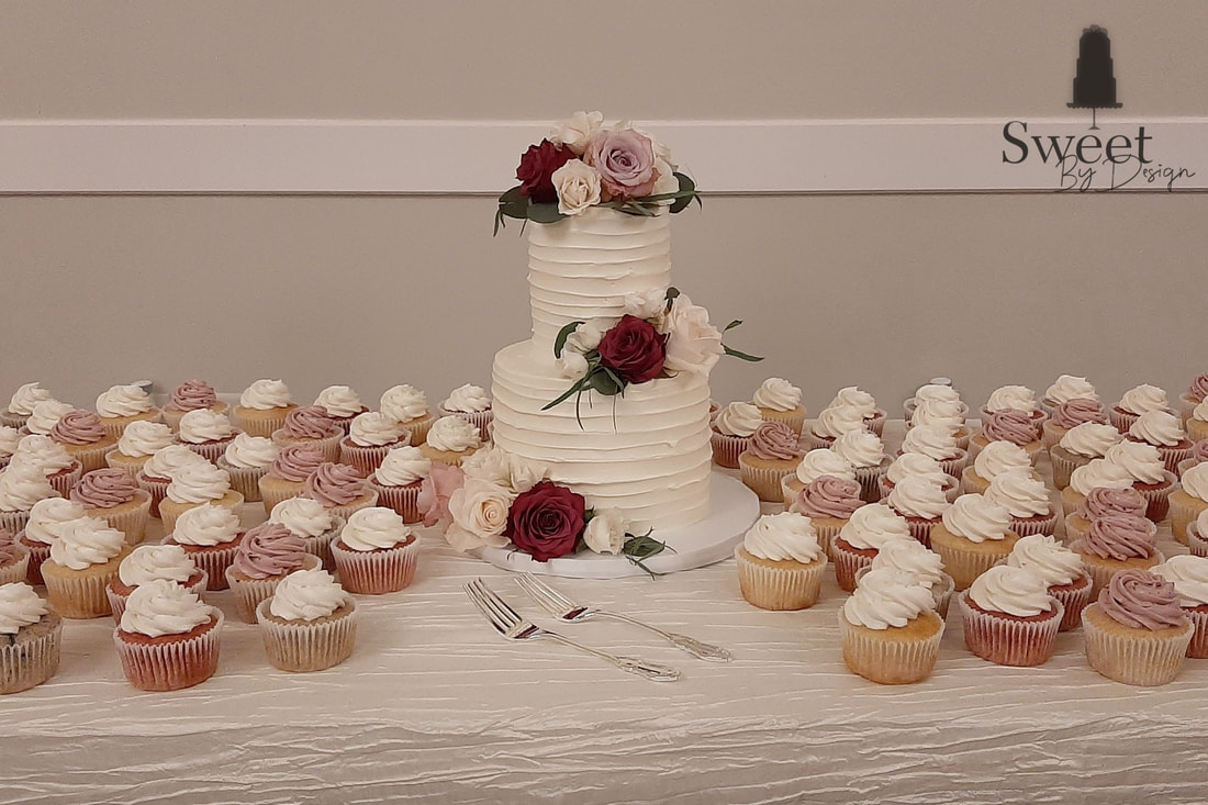 Small wedding cake and cupcakes