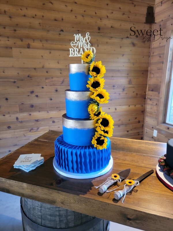 Blue ruffle and gold wedding cake by Sweet By Design