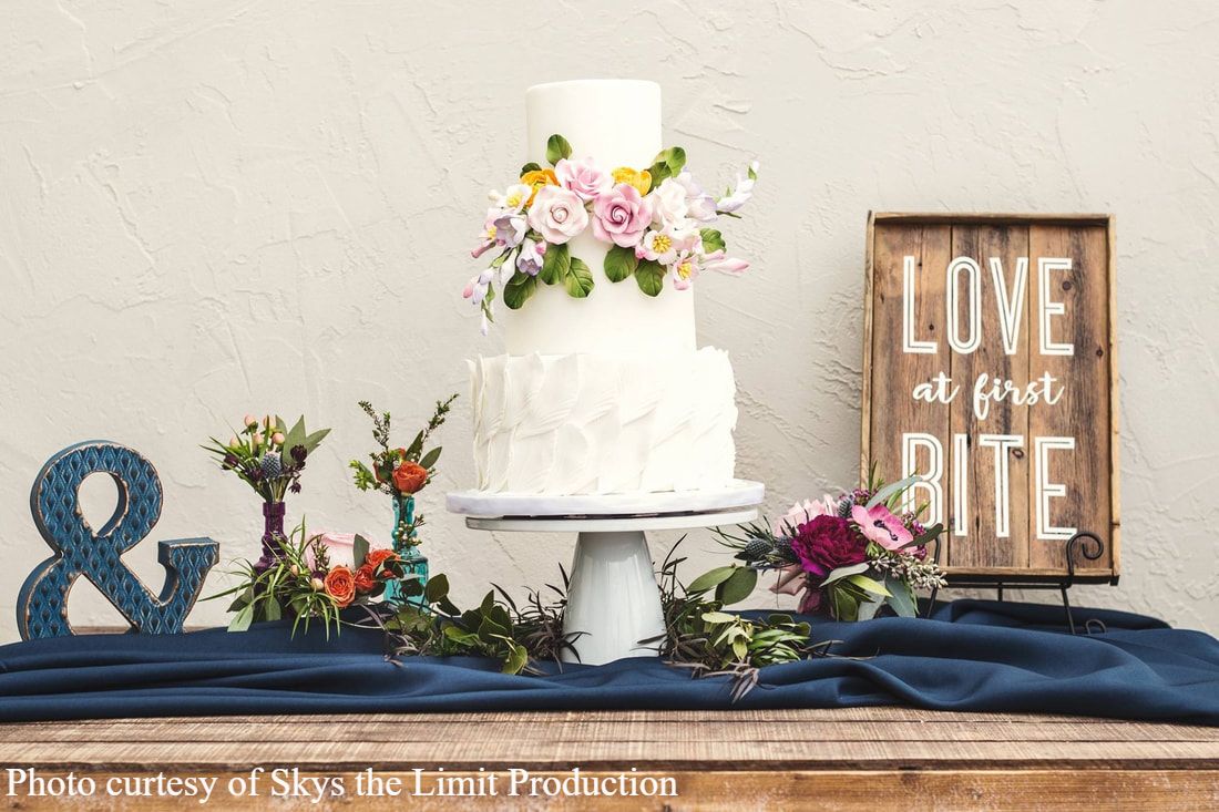 Fondant feather and flower wedding cake by Sweet By Design